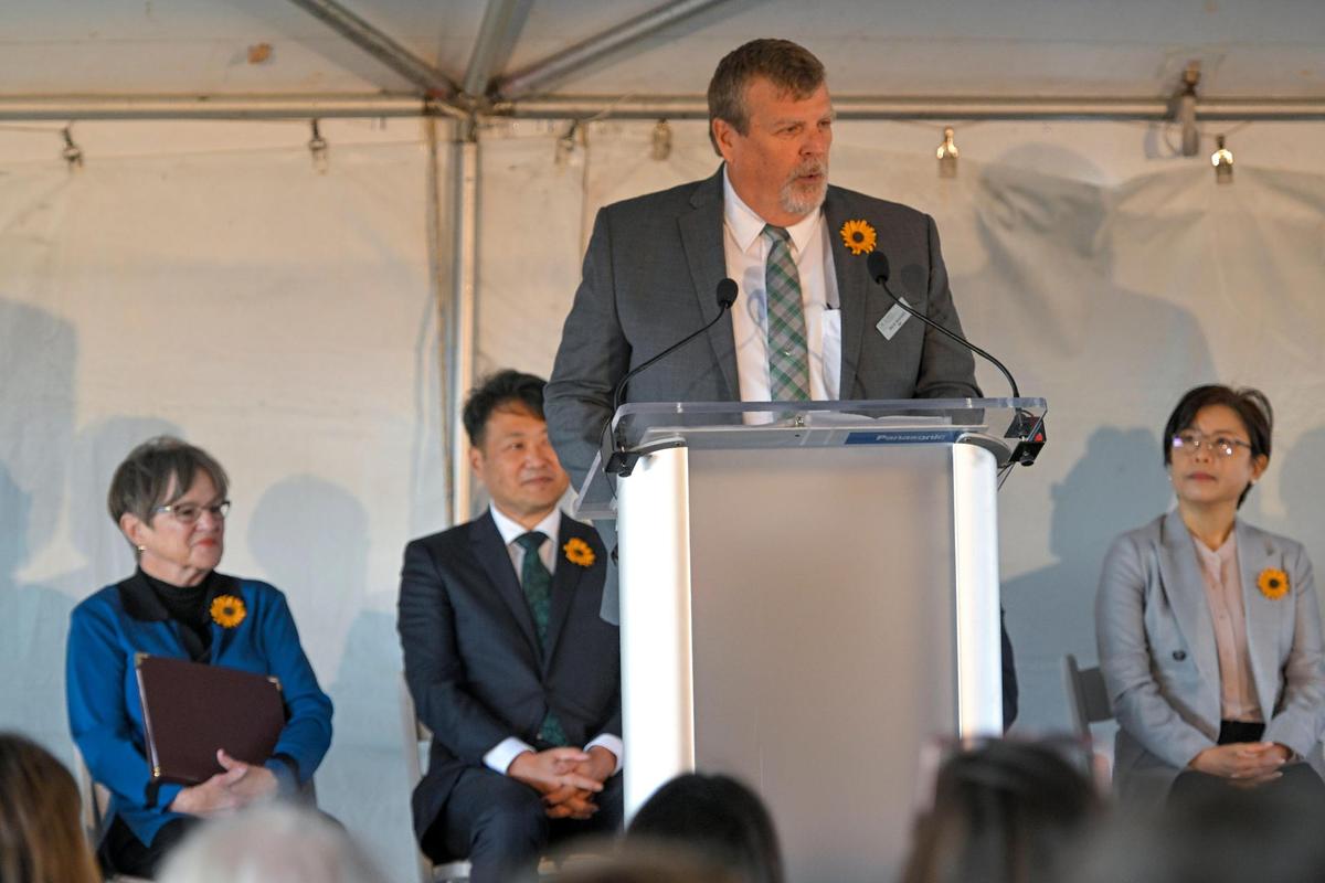 As Gov. Laura Kelly and Panasonic executives look on, Rick Walker, mayor of De Soto, Kansas, speaks during the groundbreaking ceremony on Nov. 2 for the Panasonic battery plant that will be built on the former Sunflower Army Ammunition Plant property in De Soto in Johnson County.
