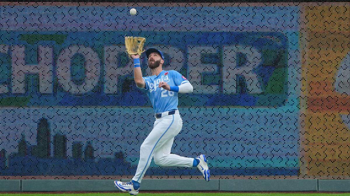 May 26, 2025; Kansas City, Missouri, USA; Kansas City Royals right fielder John Rave (26) fields a fly ball against the Cincinnati Reds in the third inning at Kauffman Stadium. Mandatory Credit: Denny Medley-Imagn Images