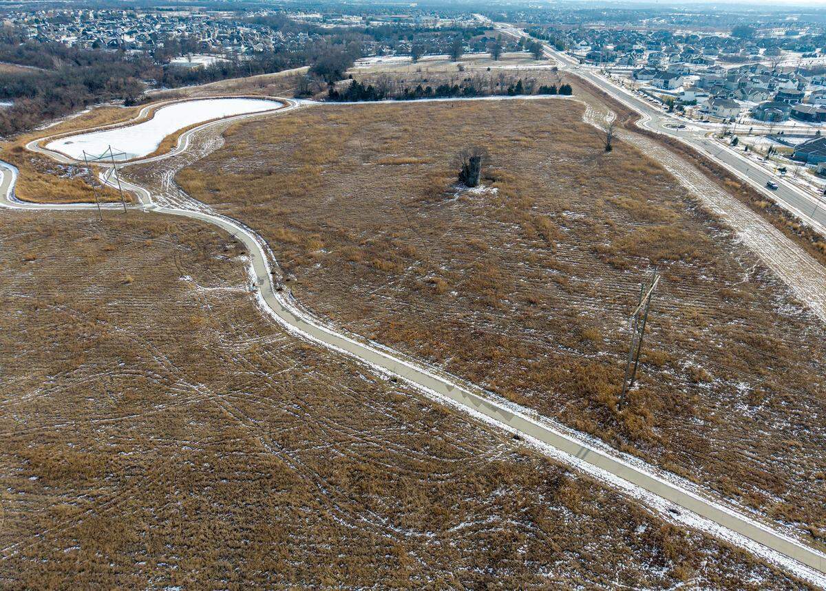The Clear Creek Trail, located off of Clare Road near 86th Terrace in Lenexa, is seen on Monday, Feb. 2, 2026. The walking trail leads to a small lake and a wetlands area. There is a proposal before the city for a 50-home Habitat for Humanity development on the land.  