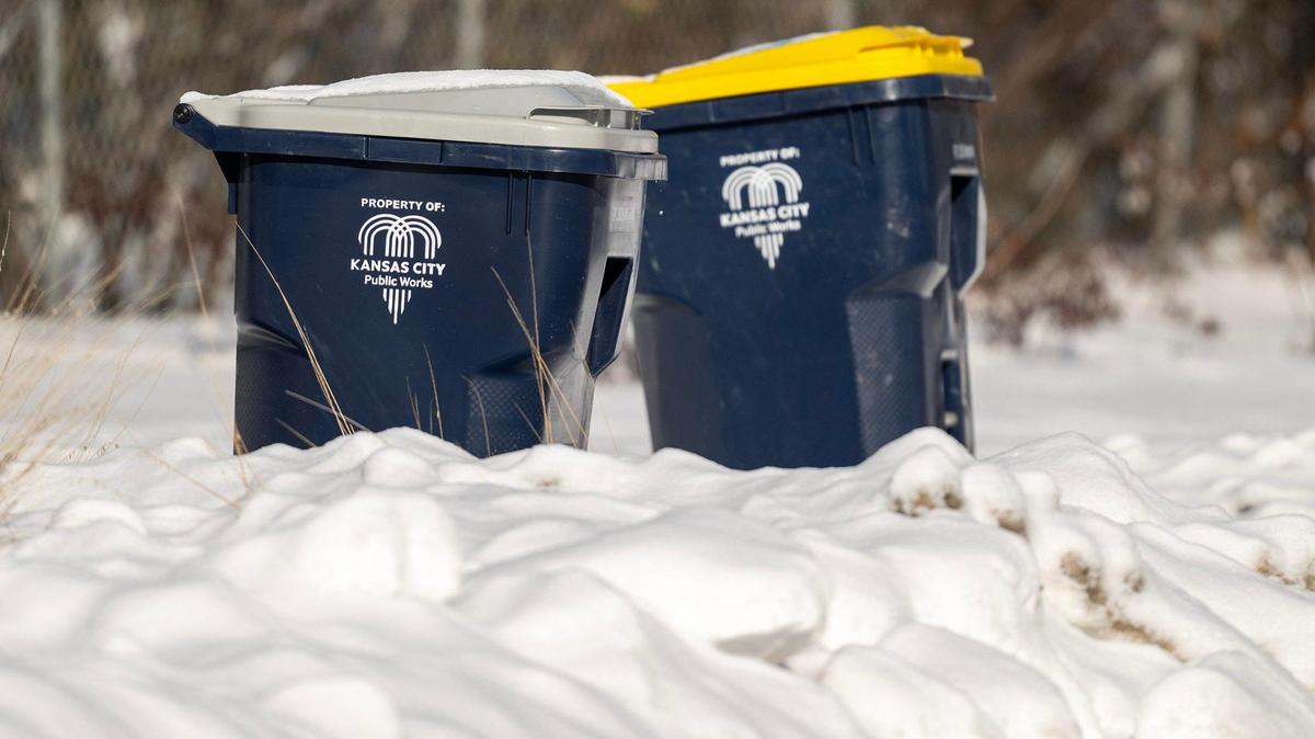 Snow surrounds trash awaiting pickup Friday, Jan. 10, 2025, in Kansas City. 