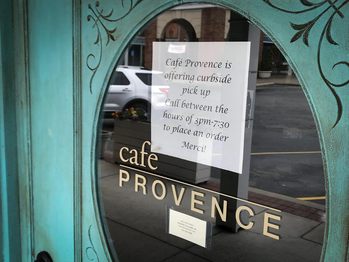 Cafe Provence in the Shops of Prairie Village posted a sign telling customers they are providing curbside pickup.