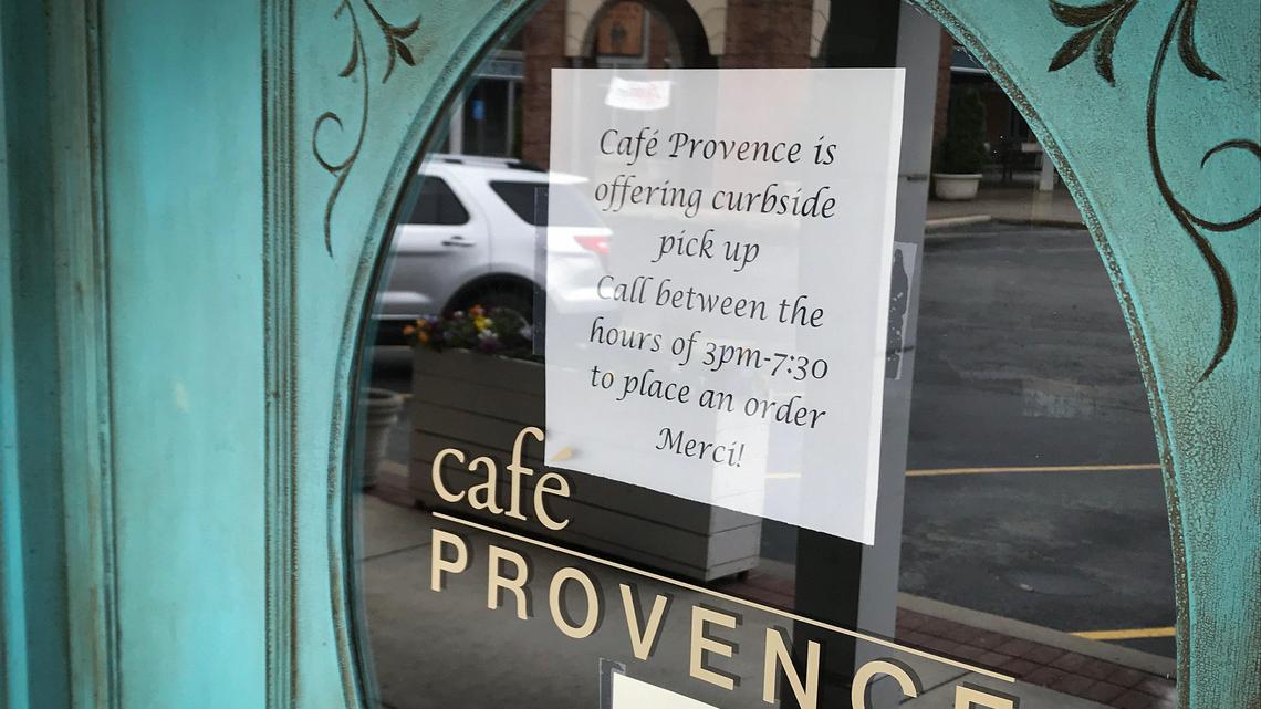 Cafe Provence in the Shops of Prairie Village posted a sign telling customers they are providing curbside pickup. Many business have scaled back or closed because of the coronavirus.