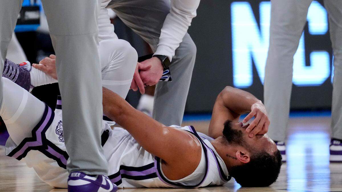 Mar 23, 2023; New York, NY, USA; Kansas State Wildcats guard Markquis Nowell (1) grabs his leg as he lies on the court during a stop in play against the Michigan State Spartans in the second half at Madison Square Garden. Mandatory Credit: Robert Deutsch-USA TODAY Sports