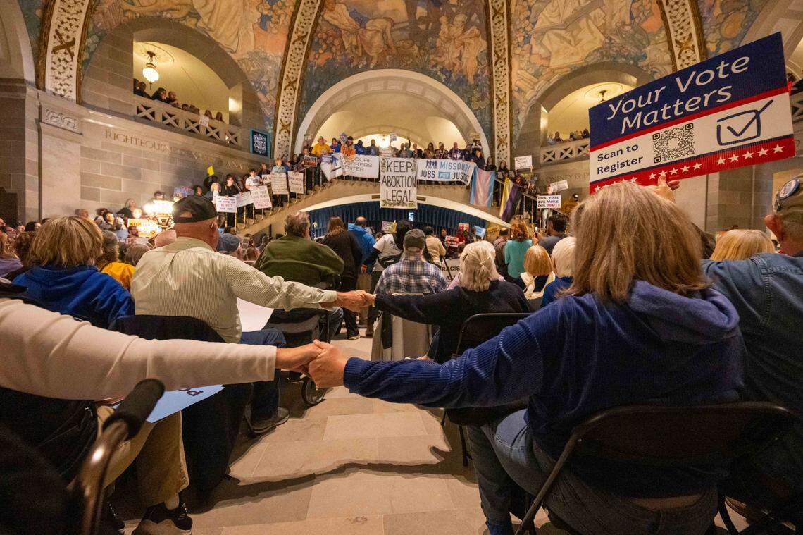 Protesters reach across the aisle in solidarity in the Missouri State Capitol rotunda on Wednesday, January 21, 2026 in Jefferson City. Organizations and allies gathered to protest recent Missouri lawmaker's decisions.