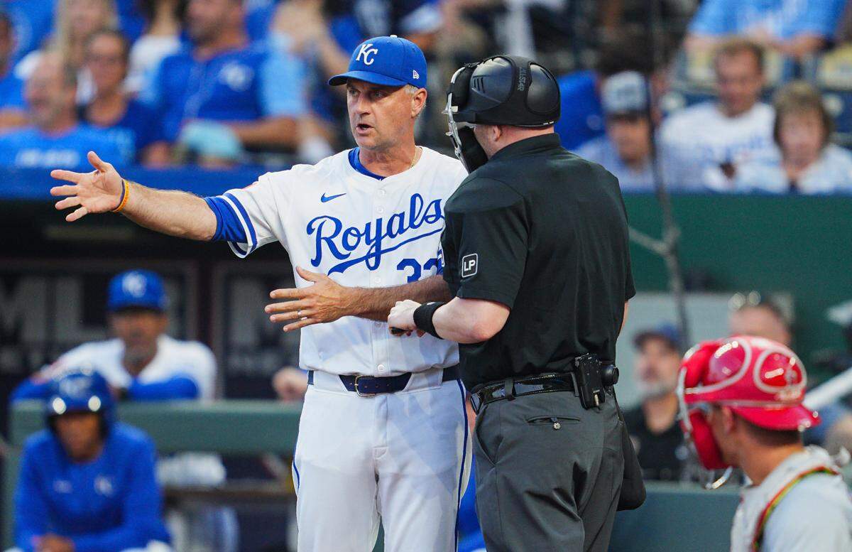 Kansas City Royals manager Matt Quatraro, left, talks with umpire Mike Estabrook during the second inning of Wednesday evening’s game against the L.A. Angels at Kauffman Stadium.