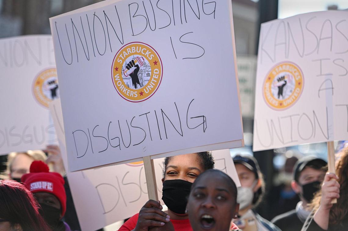 Nakisha Eubanks with Stand Up KC holds a sign in support of Starbucks employees. Eubanks works for Burger King. Dozens of Starbucks employees and union supporters protested alleged anti-union tactics by the company at the Country Club Plaza Starbucks Thursday, March 3, 2022.