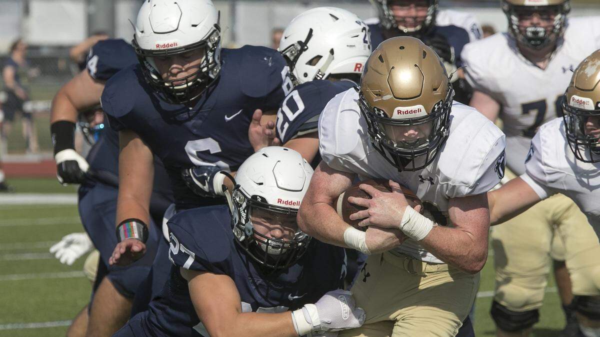 Saint Thomas Aquinas quarter back # 10, Blake Anderson was tackled by the Mill Valley defense during the Friday September 27, 2019 game at Mill Valley.