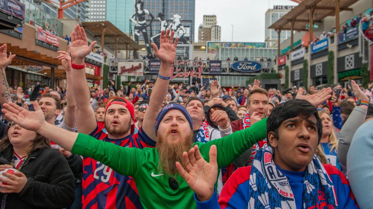 Chris Baldwin, center, chants with a crowd of fans at a World Cup watch party at the Power and Light District to see the USMNT take on Iran in the tournament on Tuesday, Nov. 29, 2022.