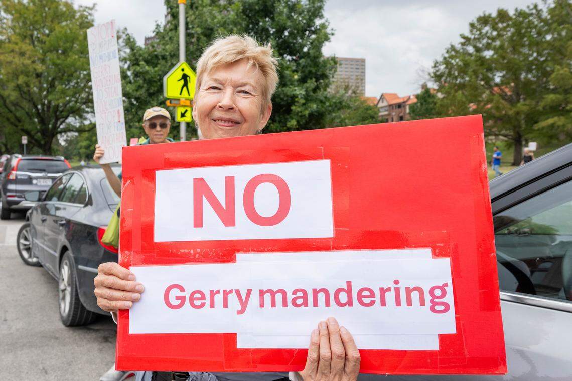 Lois Belser of Kansas City holds a sign against gerrymandering during a Labor Day rally put together by several labor unions and organizations, on Monday, Sept. 1, 2025, at Mill Street Park in Kansas City.