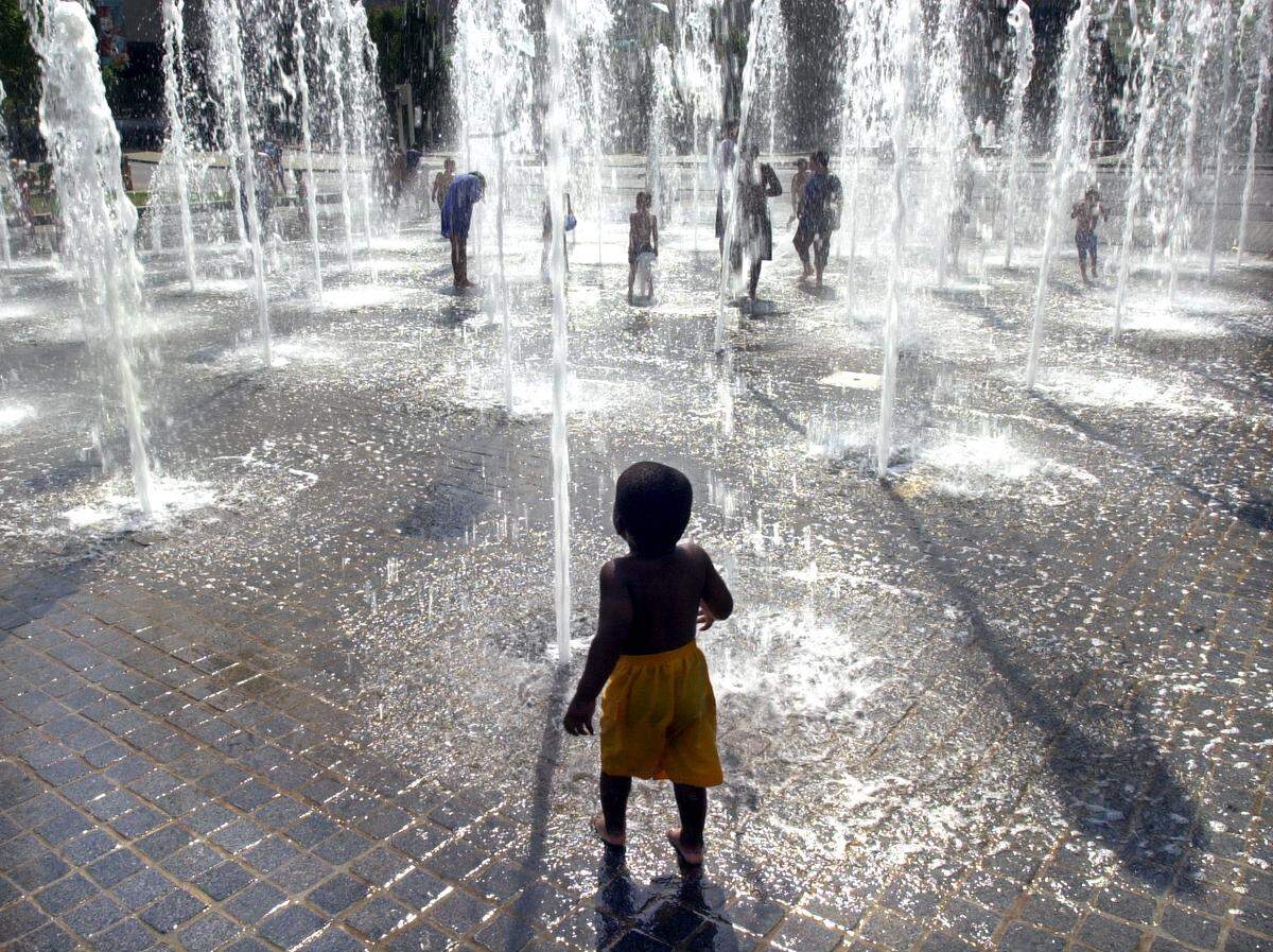 Gabirel Howell, 2, is a bit nervous about jumping in to the fountain in front of Crown Center in 2003.