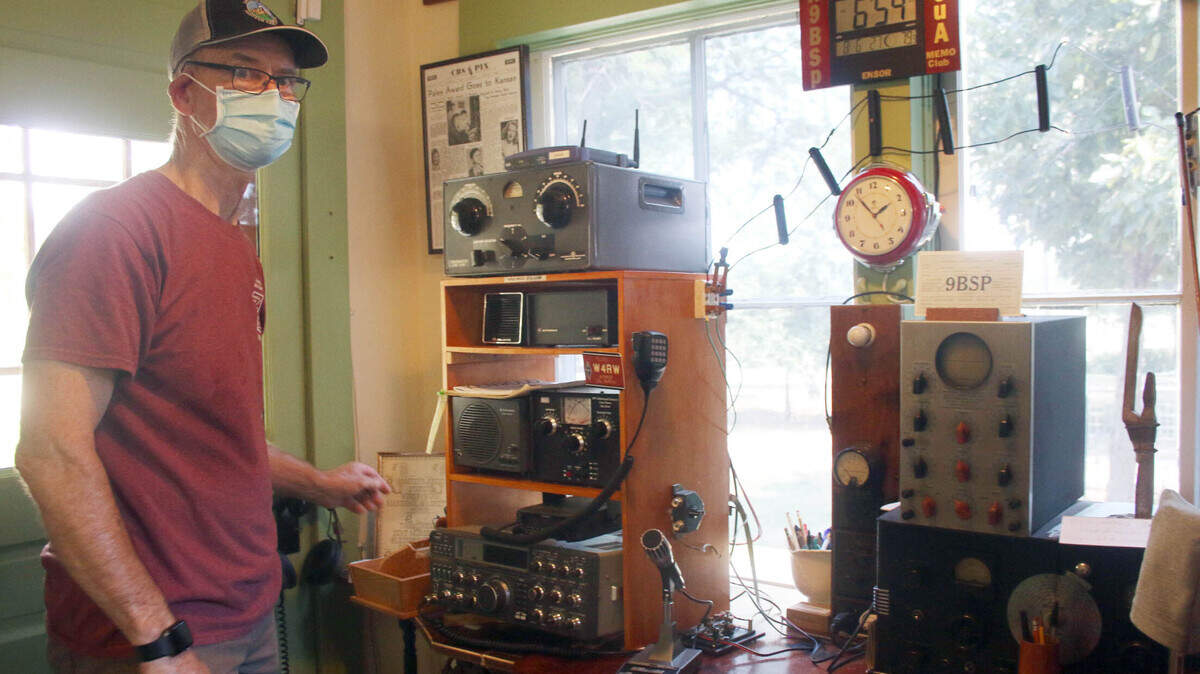 Marty Peters, who often leads tours of the Ensor Park and Museum, shows some of the antique radio equipment on display inside the Ensor home.
