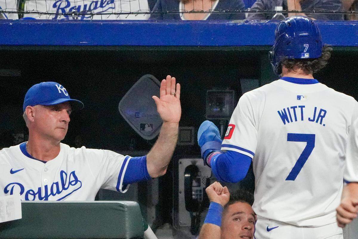  Kansas City Royals manager Matt Quatraro, left, congratulates shortstop Bobby Witt Jr. for scoring during a game against the Yankees at Kauffman Stadium.