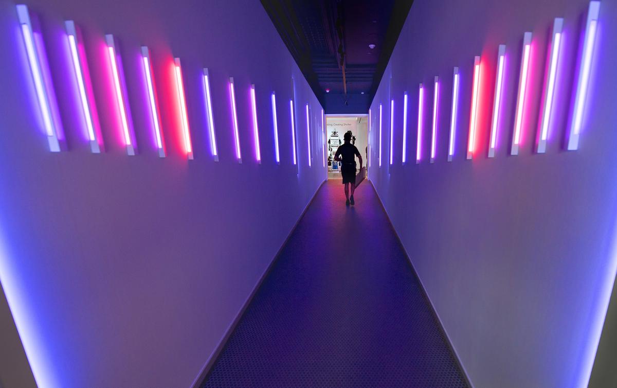 Visitors to the new 21c Museum Hotel Kansas City enter the building through a tunnel lined with color-changing LED lights. The permanent art installation by Luftwerk is called "Linear Sky."