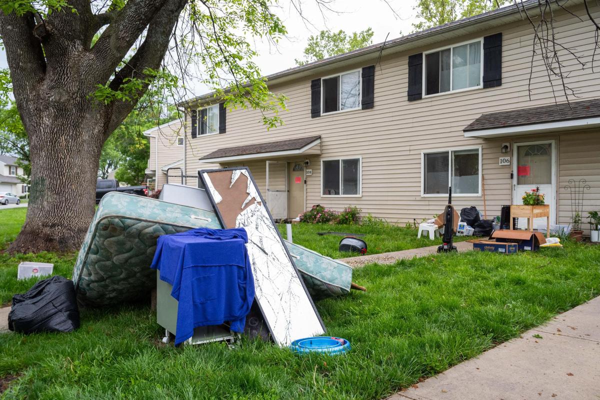 A pile of belongings sit in the grass at Aspen Place Apartments in Gardner on Wednesday, May 7, 2025. Residents of the apartment complex were forced from their homes after the city condemned the property due to several safety concerns.