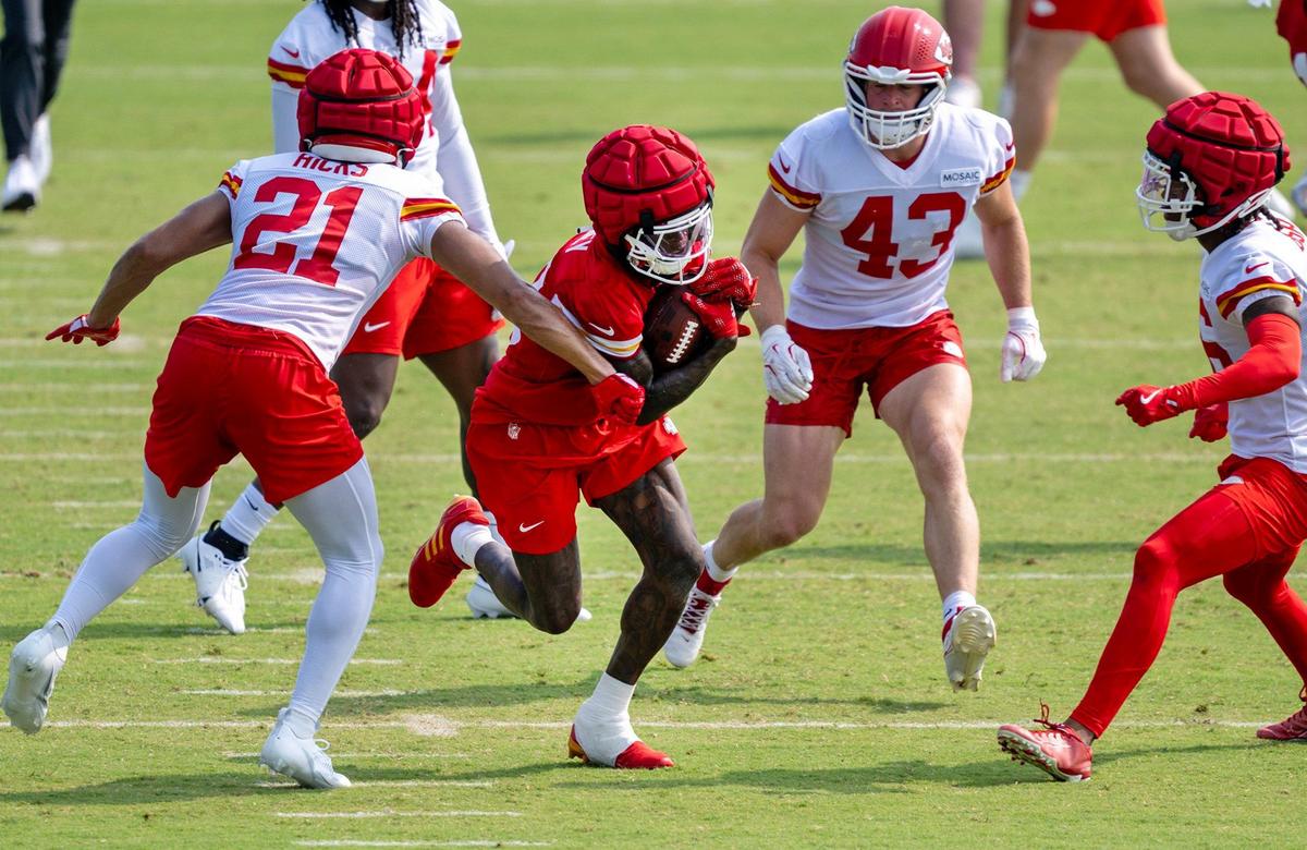Playing some running back, Kadarius Toney, second from left, gets past defensive back Jaden Hicks and linebacker Jack Cochrane during Kansas City Chiefs training camp at Missouri Western State University on Tuesday, July 23, 2024, in St. Joseph, Mo.