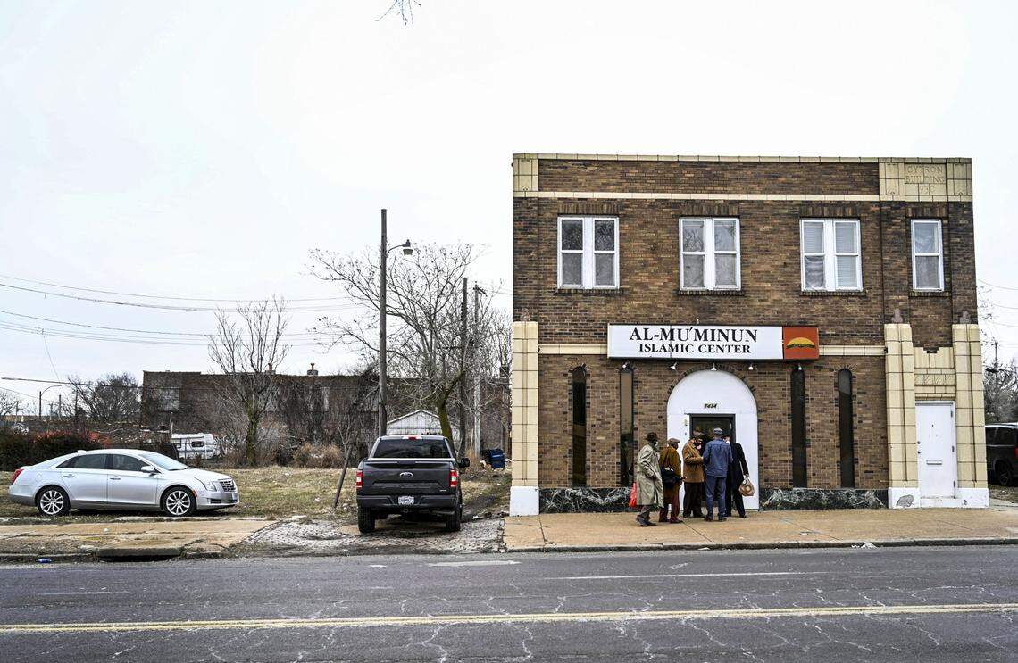 Imam Jihad Mu’Min chats with friends outside of Al-Mu’minun Islamic Center after Friday prayer on North Grand Boulevard in St. Louis on Friday, Feb. 26, 2021. Photo by Cheyenne Boone, cboone@post-dispatch.com