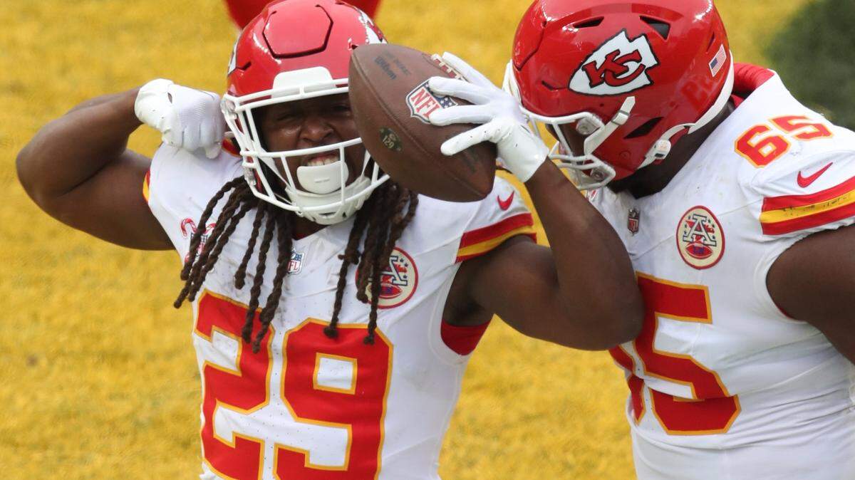 Dec 25, 2024; Pittsburgh, Pennsylvania, USA; Kansas City Chiefs running back Kareem Hunt (29) reacts with guard Trey Smith (65) after Hunt scored a touchdown against the Pittsburgh Steelers during the fourth quarter at Acrisure Stadium. Mandatory Credit: Charles LeClaire-Imagn Images