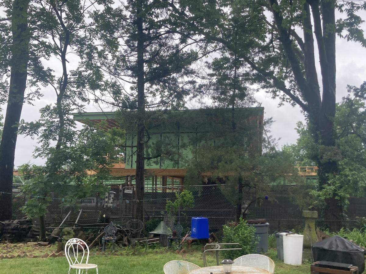 A new 10,000-square-foot modern home on Ward Parkway as seen from the backyard of West 63rd Street neighbors Moira Bird and Eugene Goldman. Goldman, 75, has lived in his home since childhood.