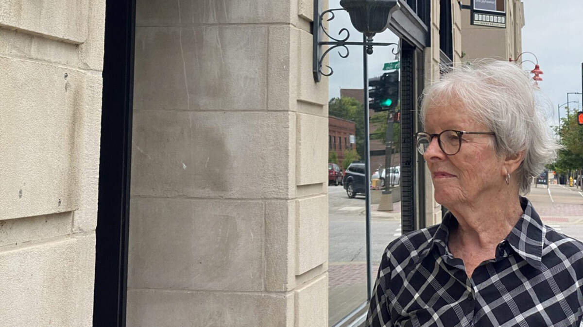 Pat Kehde stands outside Lawrence’s Eldridge Hotel, which was destroyed twice by Missouri forces during the border war.
