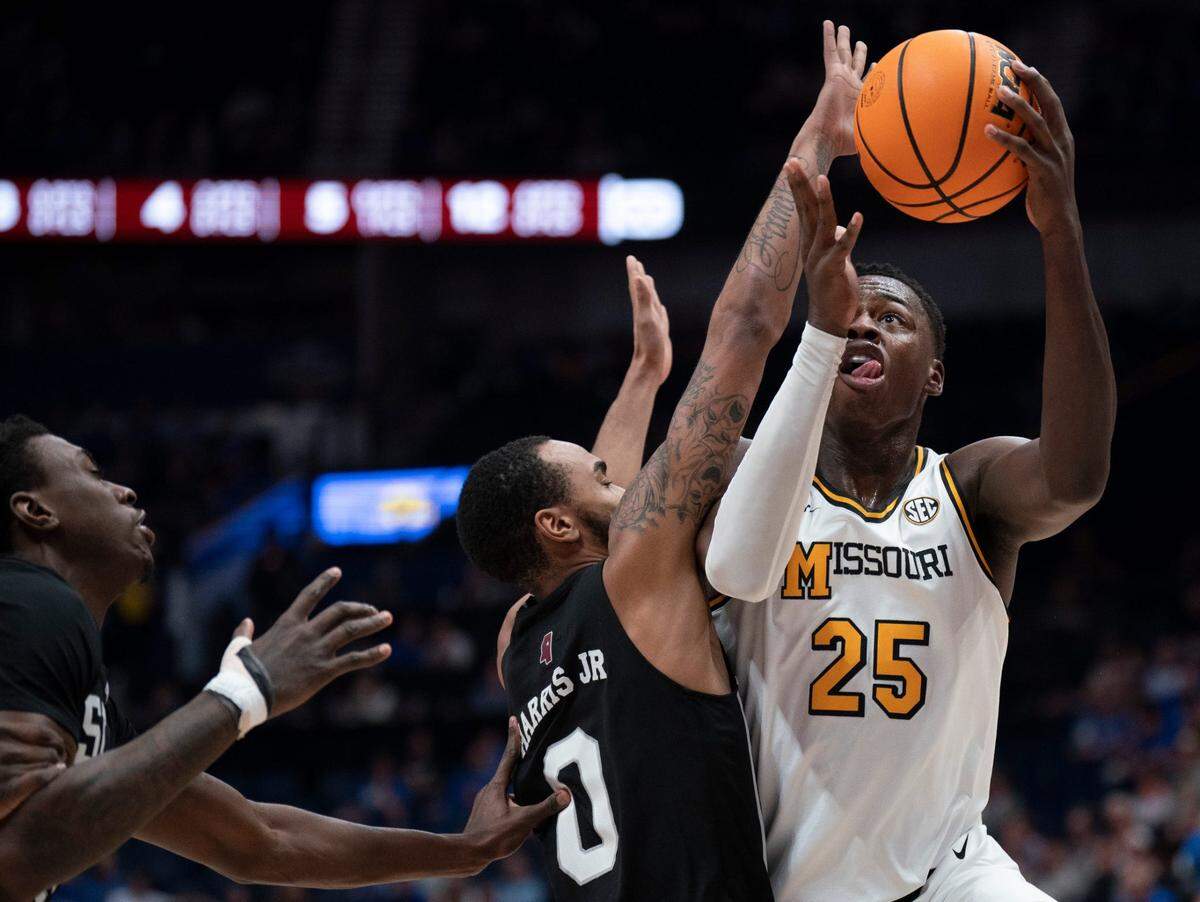 Missouri Tigers guard Mark Mitchell (25) shoots over Mississippi State Bulldogs guard Claudell Harris Jr. (0) during their second round game at the SEC Men’s Basketball Tournament at Bridgestone Arena in Nashville on Thursday, March 13, 2025.