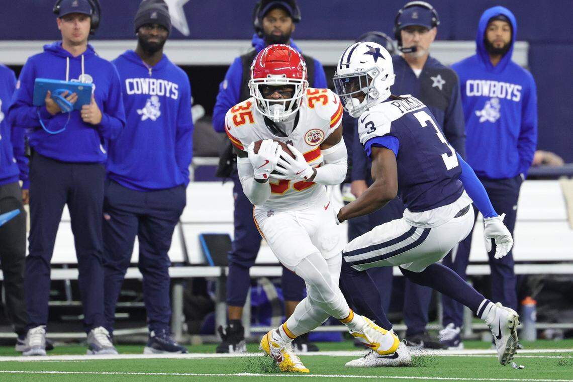 Kansas City Chiefs cornerback Jaylen Watson intercepts a pass intended for Cowboys wide receiver George Pickens, right, during an NFL Week 13 Thanksgiving Day game at AT&T Stadium in Arlington, Texas on Thursday, Nov. 27, 2025.