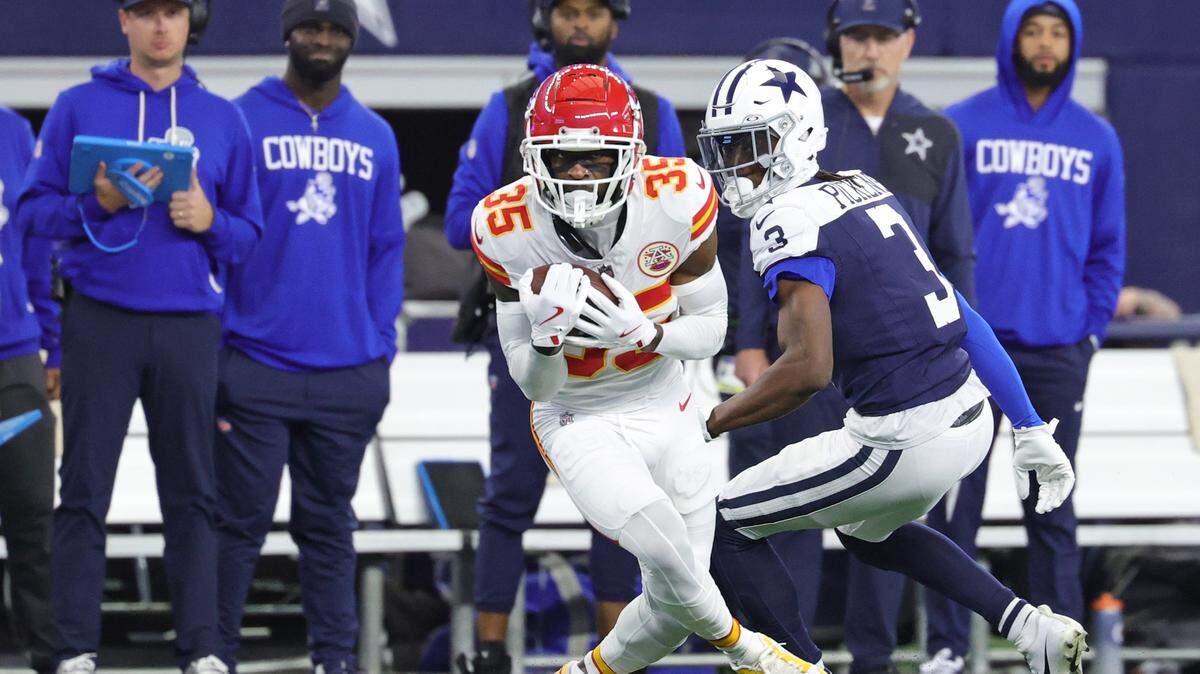 Kansas City Chiefs cornerback Jaylen Watson intercepts a pass intended for Cowboys wide receiver George Pickens, right, during an NFL Week 13 Thanksgiving Day game at AT&T Stadium in Arlington, Texas on Thursday, Nov. 27, 2025.