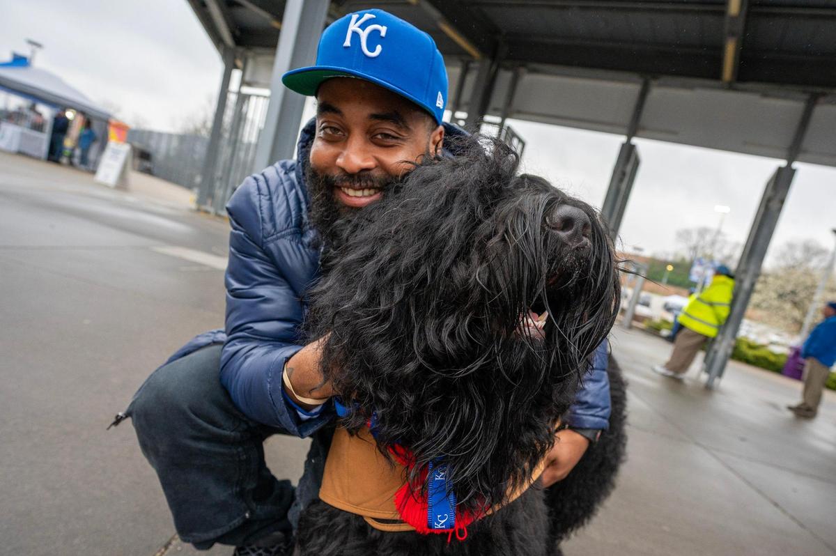 Steven Baker and his dog, Cheeseburger, pose for a portrait during Bark at the Park at an MLB game between the Kansas City Royals and the Baltimore Orioles on Friday, April 4, 2025, at Kauffman Stadium.