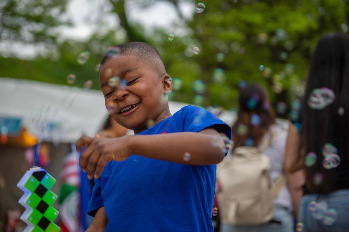 Five-year-old Brian Moore plays with a bubble machine toy during the Cinco de Mayo celebration at Guadalupe Centers on Friday, May 5, 2023, in Kansas City.