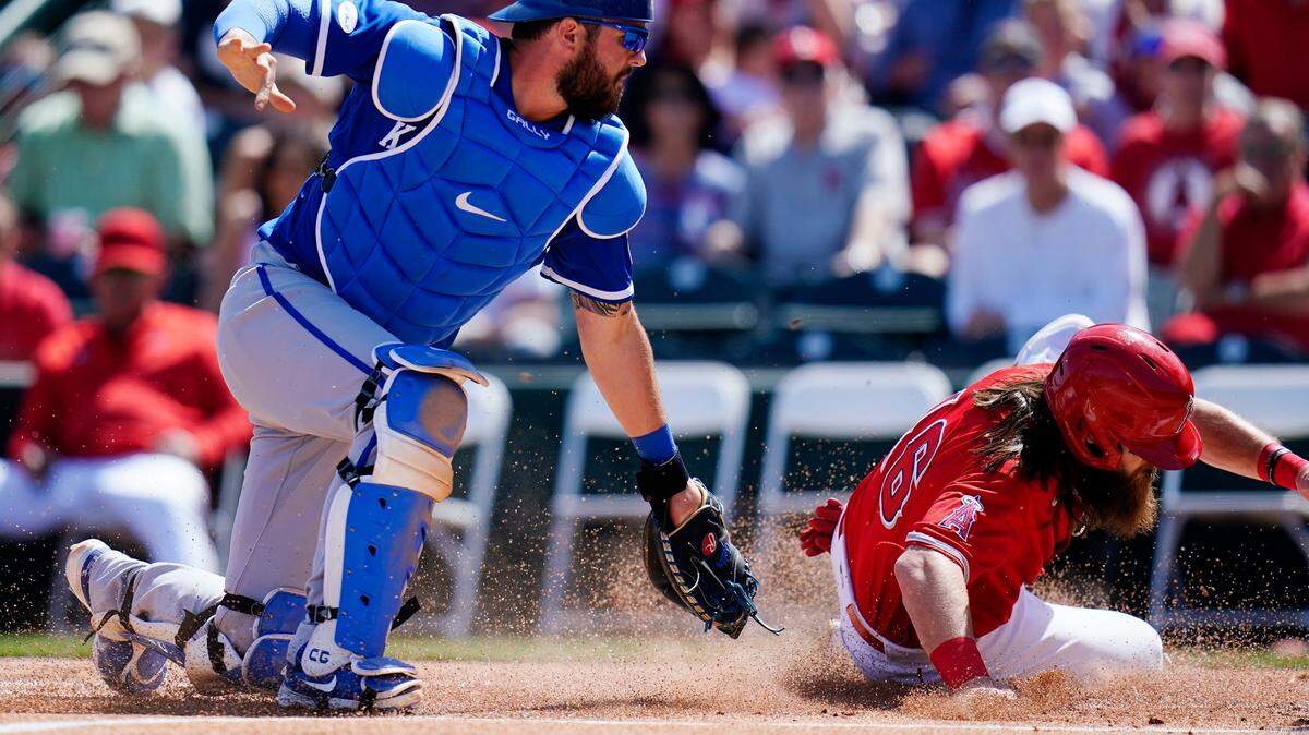 Los Angeles Angels’ Brandon Marsh, right, scores a run as Kansas City Royals catcher Cam Gallagher is unable to catch the ball during the first inning of a spring training baseball game Monday, March 21, 2022, in Tempe, Ariz. (AP Photo/Ross D. Franklin)