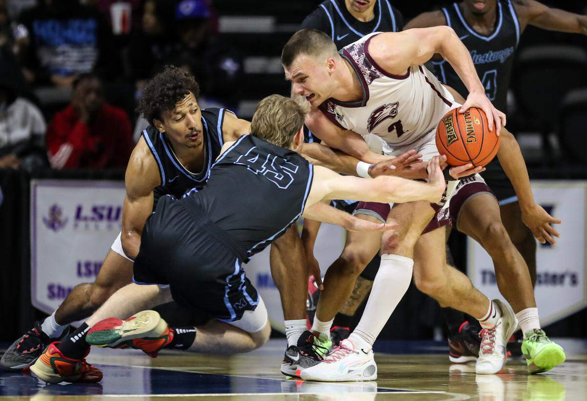 Freed-Hardeman’s Peyton Law swipes the ball from Deaken Stangl of The Master’s during a Thursday afternoon Round of 16 game at the 2024 NAIA Men’s Basketball National Championship inside Municipal Stadium in Kansas City.
