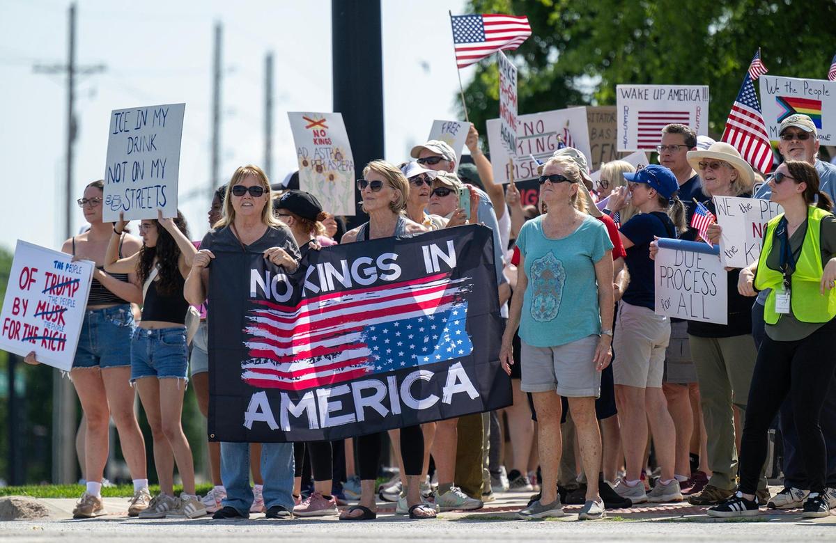 Protesters, many with ‘No Kings’ signs, spoke out, marched and rallied as part of a nationwide “No Kings” day of defiance on Saturday, June 14, 2025, in Lenexa, Kansas. The events protest President Donald Trump and immigration policies, among other issues.