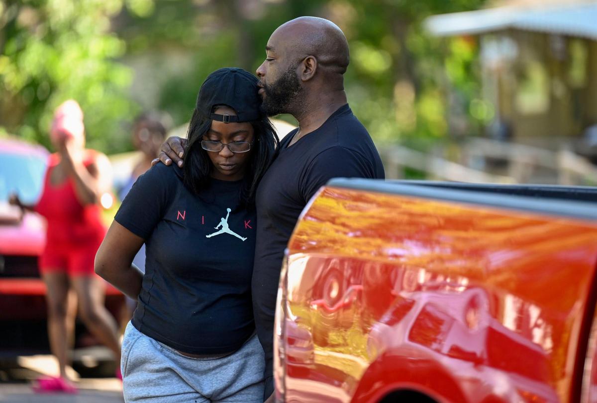 Residents gathered at 57th Street and Wabash Avenue after three people died and five were injured following a shooting early Sunday, June 25, 2023, near 57th Street and Prospect Avenue in Kansas City.
