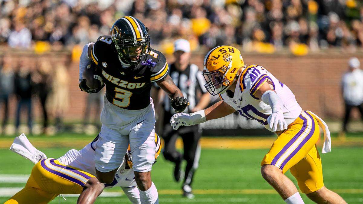 Missouri wide receiver Luther Burden III (3) attempts to avoid a tackle from LSU linebacker Whit Weeks (40) on Saturday, October 7, 2023, in Columbia.