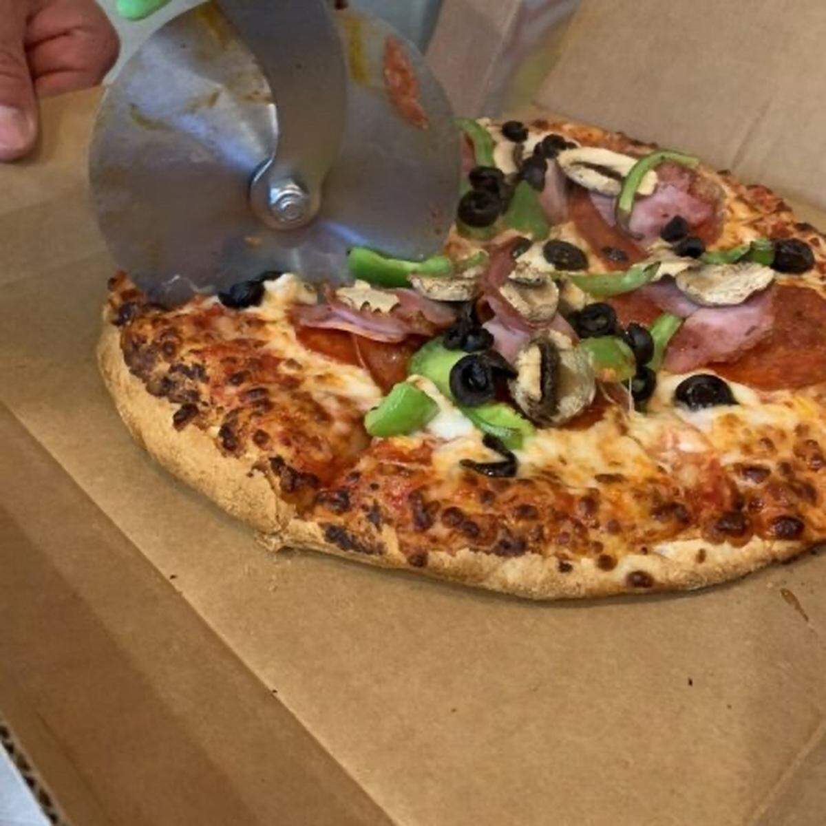 Pizza Shuttle’s Express pie includes the standard cheese topped with pepperoni, ham, mushrooms, onions and green peppers.