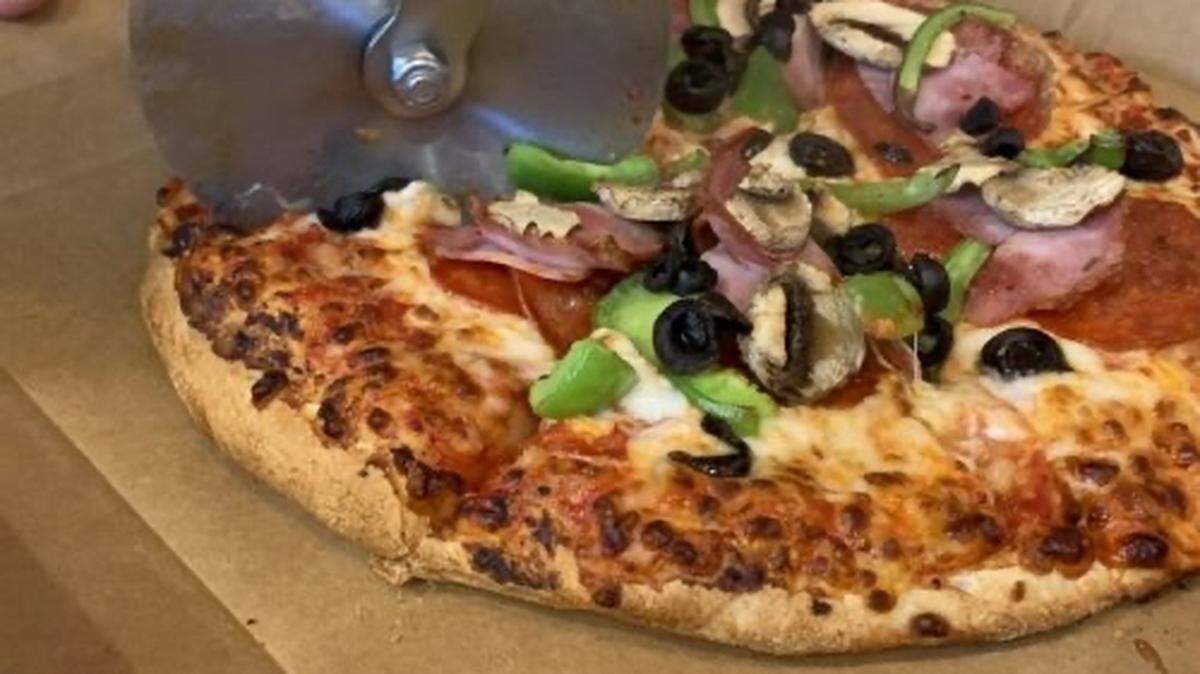 Pizza Shuttle’s Express pie includes cheese topped with pepperoni, ham, mushrooms, onions and green peppers.