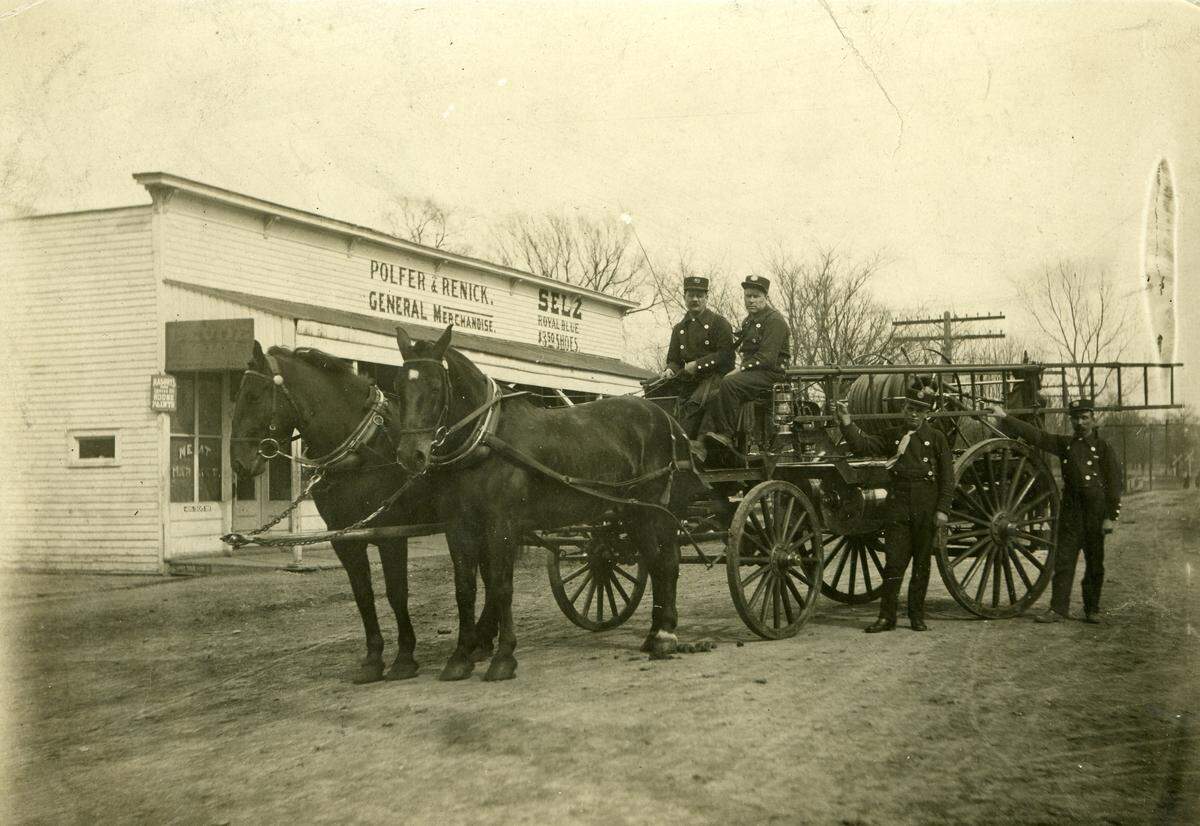 Early-1900s photograph of Leeds firefighters and a fire wagon outside the Polfer & Renick General Store.