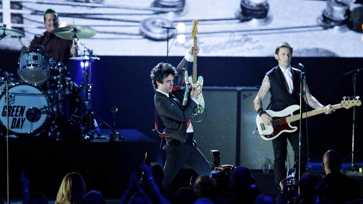 In this April 18, 2015, file photo, Billie Joe Armstrong, center, drummer Tre Cool and guitarist Mike Dirnt, of Green Day perform at the Rock and Roll Hall of Fame Induction Ceremony in Cleveland.