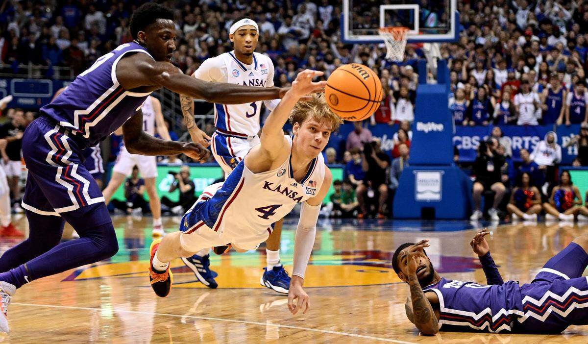 Gradey Dick dives for a loose ball between TCU’s Damion Baugh and Rondel Walker during the first half of a Big 12 Conference game at Allen Fieldhouse.