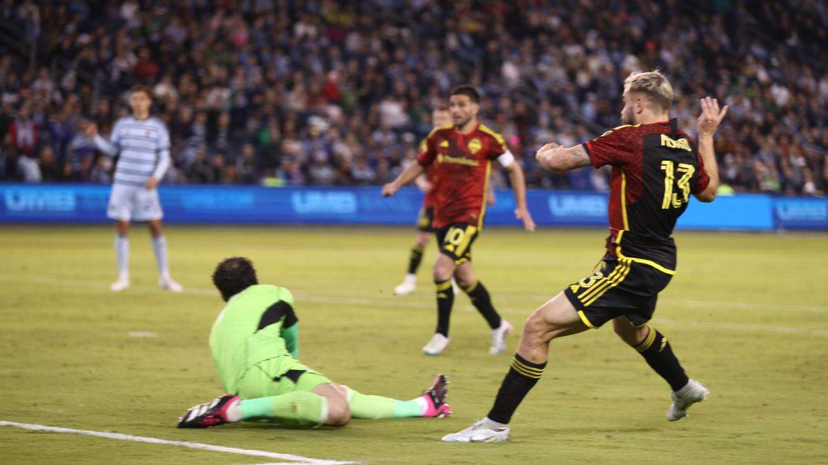 Seattle Sounders forward Jordan Morris (13) scores one of his four goals against Sporting Kansas City at Children’s Mercy Park on March 25, 2023.