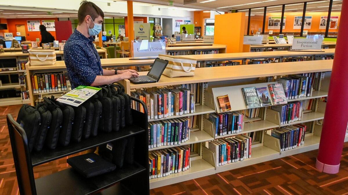Chromebook computers are now available from the Kansas City Public Library for patrons to check out for up to 21 days at a time. Sunny Branick, branch manager at the Lucile H. Bluford branch, booted up one of the branches’ 40 computers on Thursday, July 14, 2022, in Kansas City. The Chromebooks have a Wi-Fi connection and do not need to have a Wi-Fi at home to use. The Kansas City Public Library system has 900 Chromebooks available to checkout throughout the branches.