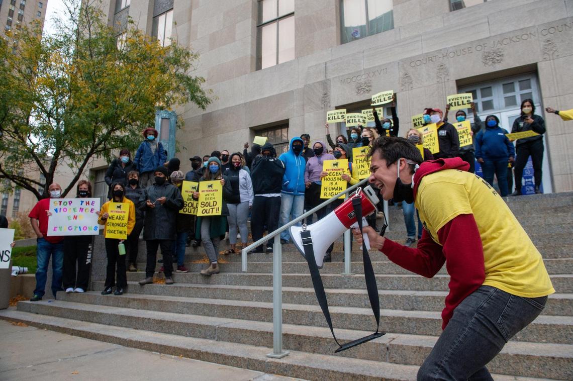 Mason Andrew Kilpatrick of KC Tenants leads protesters in a chant at the west entrance to the Jackson County Courthouse in downtown Kansas City Thursday morning.