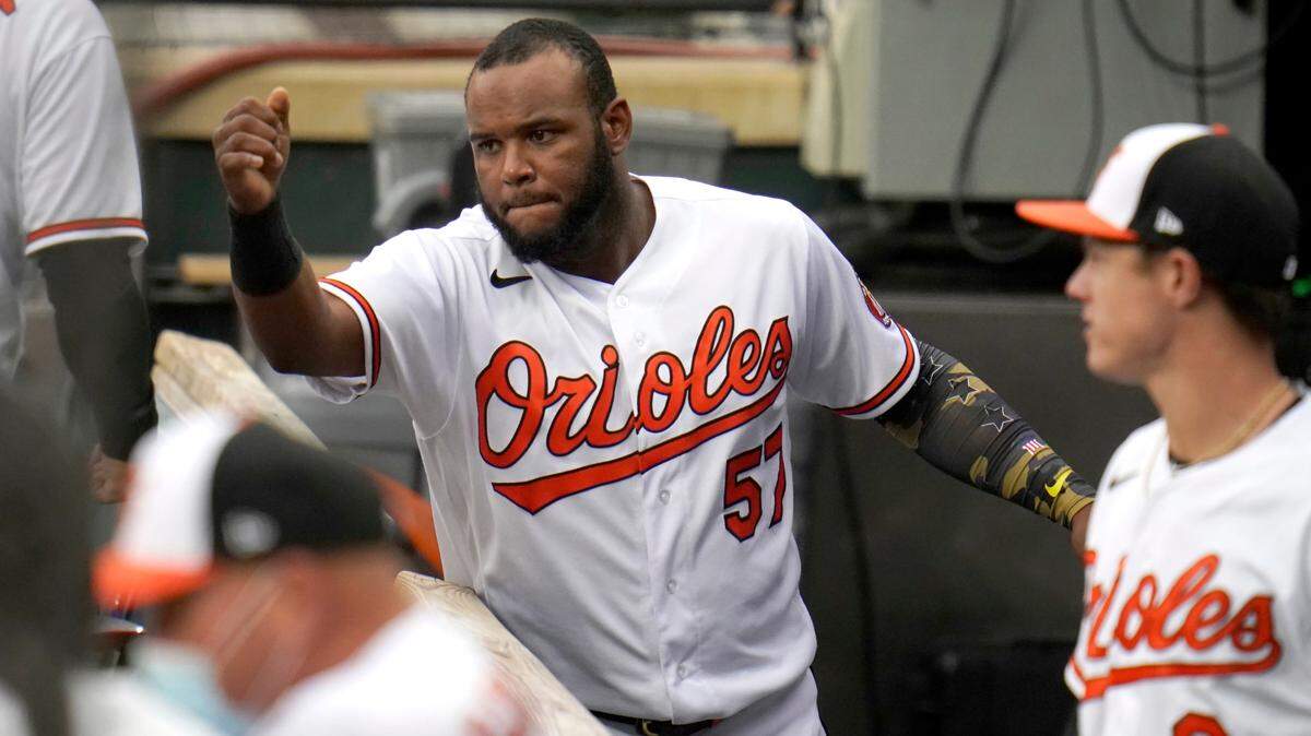Baltimore Orioles third baseman Hanser Alberto (57) talks with teammates in the dugout prior to the first game of a baseball double header Tampa Bay Rays, Thursday, Sept. 17, 2020, in Baltimore. (AP Photo/Julio Cortez)