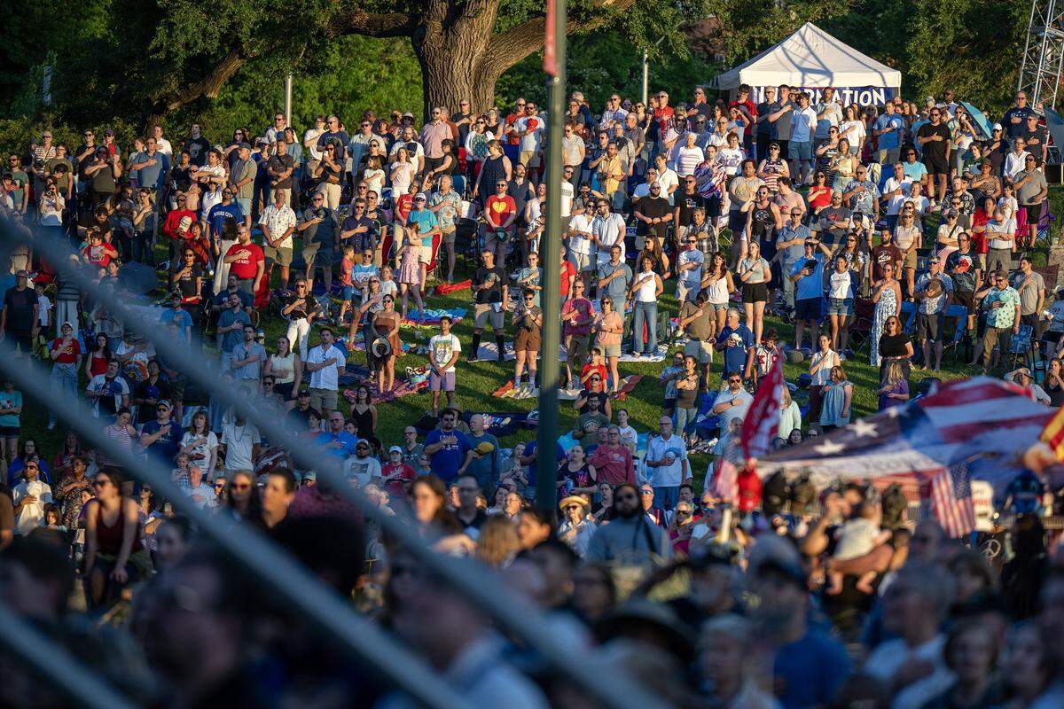 People stand during the national anthem at the Kansas City Symphony's annual Celebration at the Station concert on Sunday, May 24, 2026, at Union Station in Kansas City.