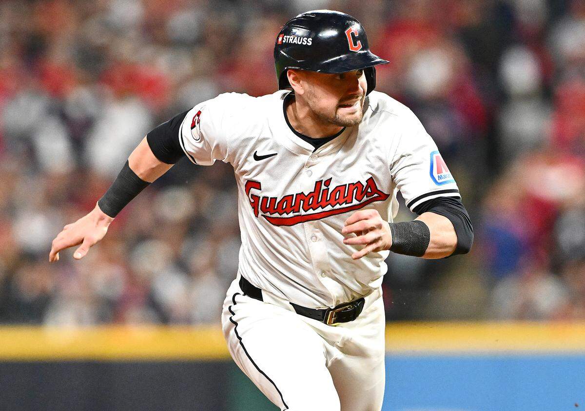 Lane Thomas of the Cleveland Guardians steals third base during the sixth inning against the New York Yankees during the American League Championship Series at Progressive Field on October 17, 2024 in Cleveland, Ohio.