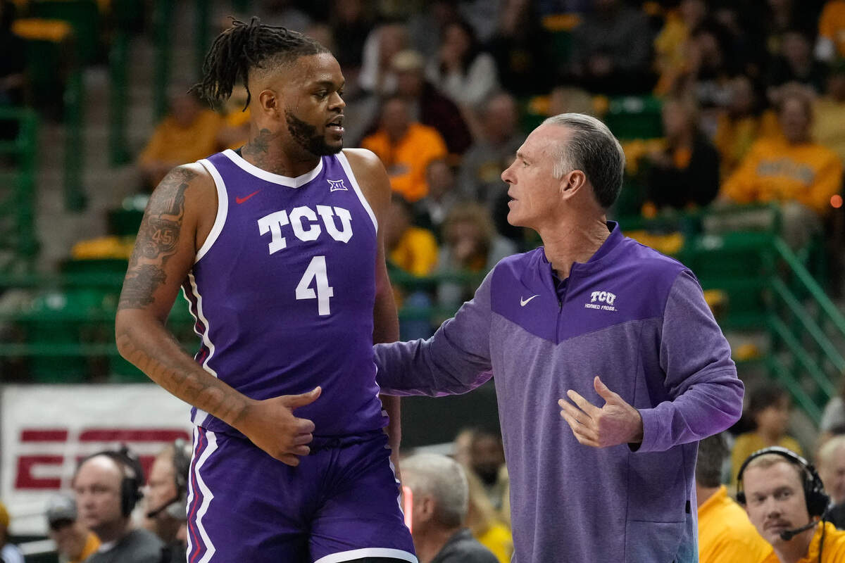 TCU Horned Frogs head coach Jamie Dixon (right) talks with center Eddie Lampkin Jr. (4) during a break in play against the Baylor Bears during the first half at Ferrell Center on Jan. 4, 2023. Lampkin left the program two months later.