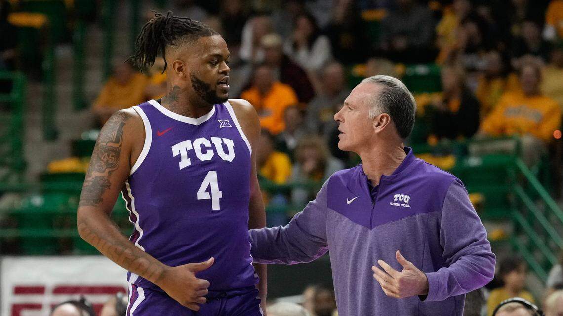 TCU Horned Frogs head coach Jamie Dixon (right) talks with center Eddie Lampkin Jr. (4) during a break in play against the Baylor Bears during the first half at Ferrell Center on Jan. 4, 2023.