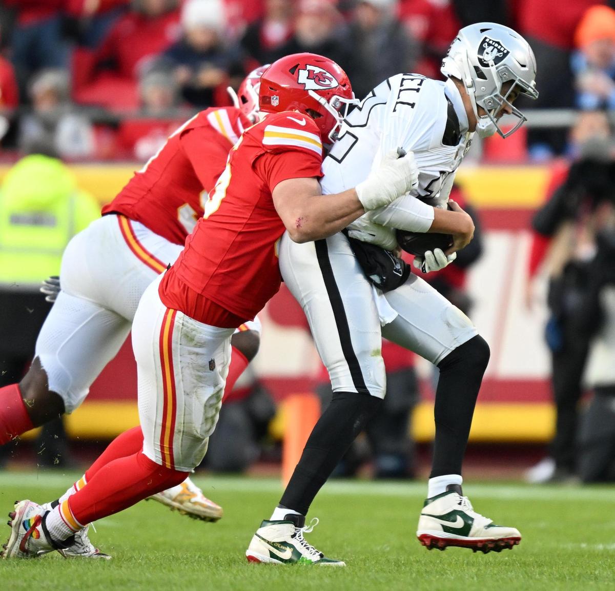 Kansas City Chiefs defensive end George Karlaftis (56) sacks Las Vegas Raiders quarterback Aidan O’Connell (12) in the third quarter on Friday, Nov. 29, 2024, at GEHA Field at Arrowhead Stadium.
