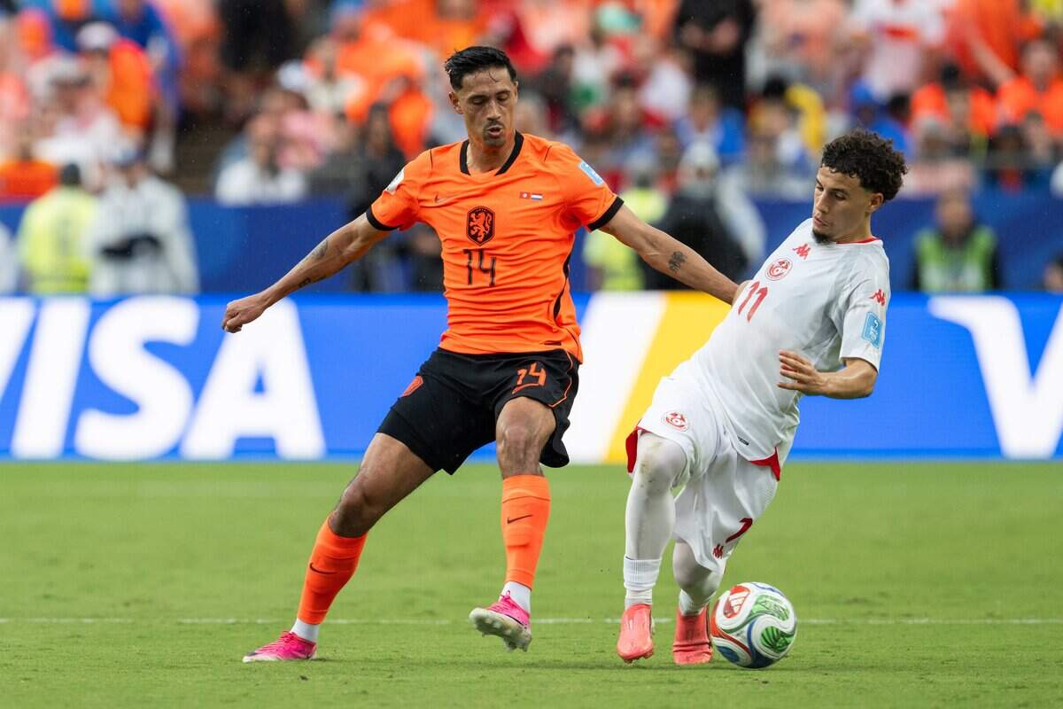 Tunisia midfielder Ismaël Gharbi (11) takes the ball away from Netherlands midfielder Tijjani Reijnders (14) in a FIFA World Cup group-stage soccer match at Kansas City (Arrowhead) Stadium in Kansas City on Thursday, June 25, 2026.