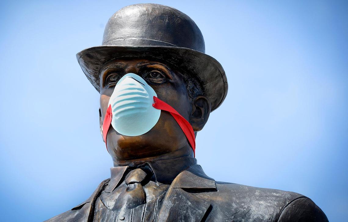 A statue of William B. Strang, founder of Overland Park, was sporting a homemade mask on Tuesday, April 7, 2020, in downtown Overland Park, Kansas.