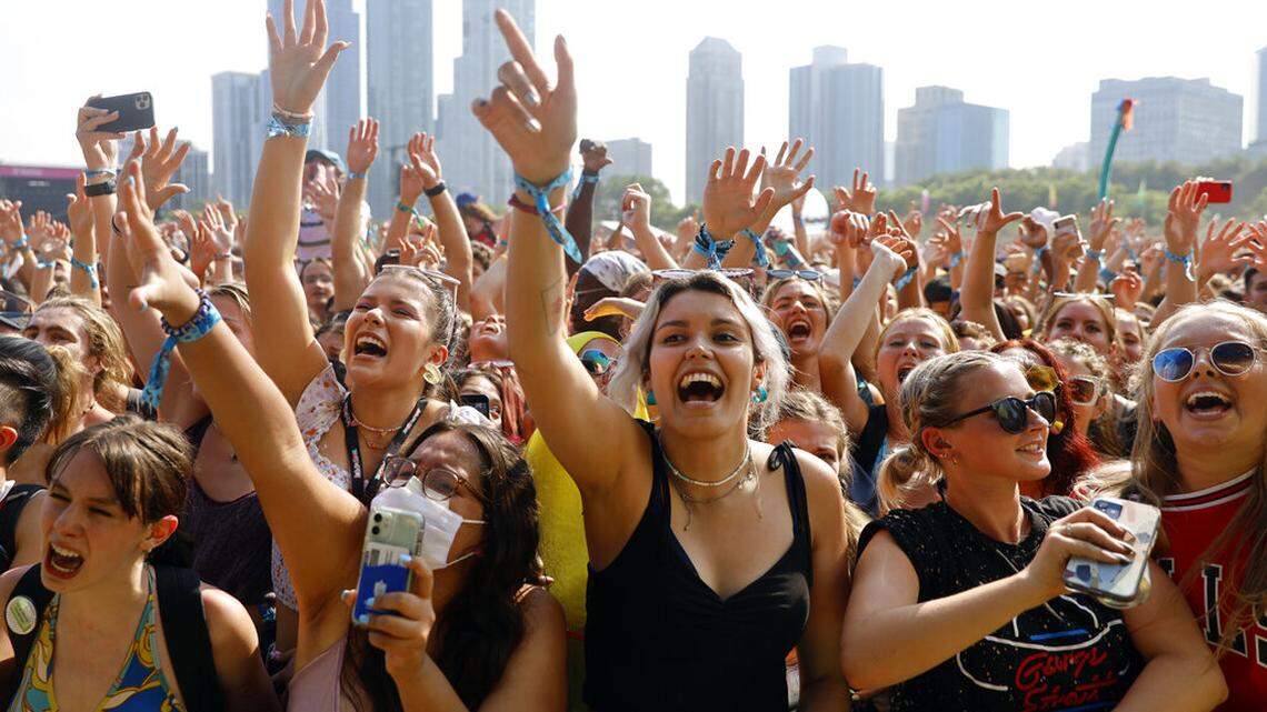 Fans cheer and wave their hands in the air on day one of the Lollapalooza music festival on Thursday, July 29, 2021, at Grant Park in Chicago. Despite concerns from some that the festival would turn into a COVID-19 super-spreader, officials said Aug. 12 it was not.